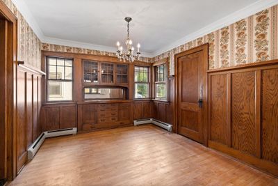 Formal dining room complete with built-in buffet and wainscoting. | Image 3