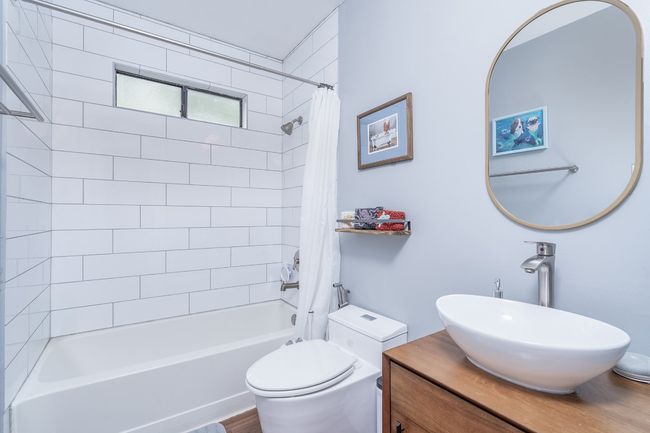 Updated bathroom with toilet, vanity, and shower / tub combo. | Image 23
