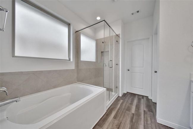 The primary suite features a relaxing garden tub and oversized shower... | Image 23