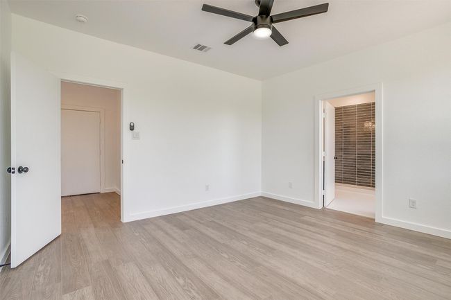 Unfurnished room with light wood-style flooring, baseboards, and a ceiling fan | Image 17