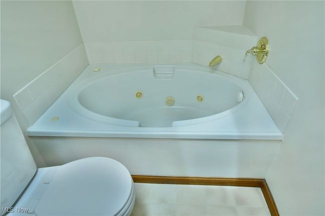 Bathroom featuring toilet and a jetted tub | Image 44
