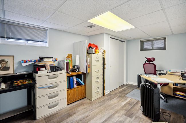 Office space featuring a drop ceiling and light wood-style flooring | Image 19