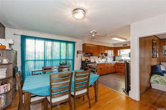 Dining room featuring light wood-style flooring and ceiling fan | Image 14