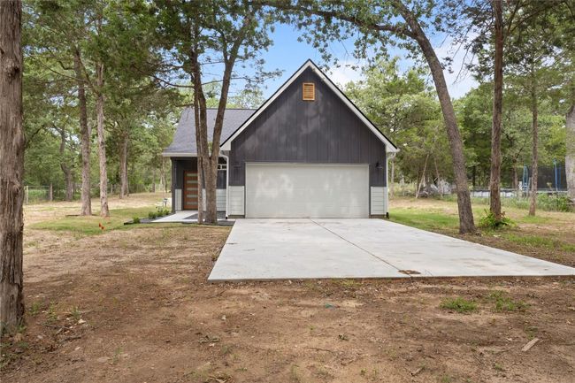 A breathtaking front view of a beautifully designed home with spacious parking on nearly an acre—ready to be yours! | Image 32