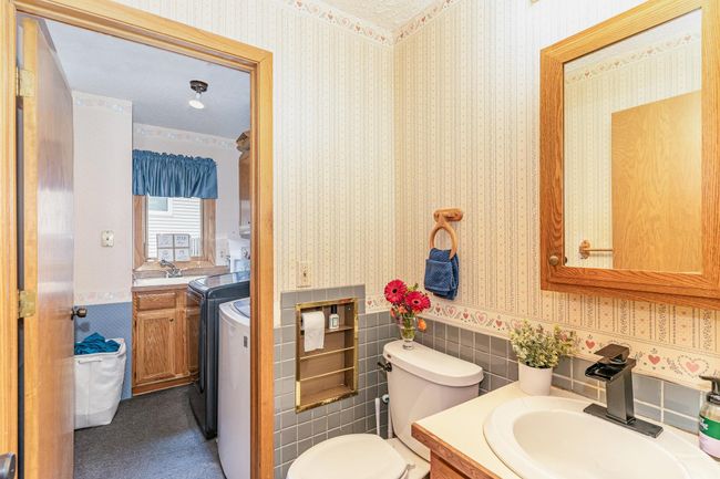 Main level powder room leading into laundry room | Image 11