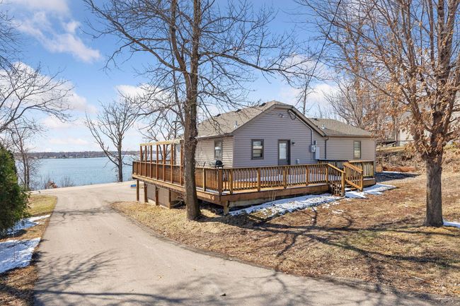 This spacious wraparound porch offers wonderful lake views, making it the perfect spot to relax and unwind. | Image 21