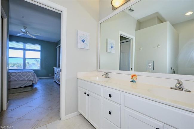 Bathroom featuring ceiling fan, tile patterned floors, and vanity | Image 39