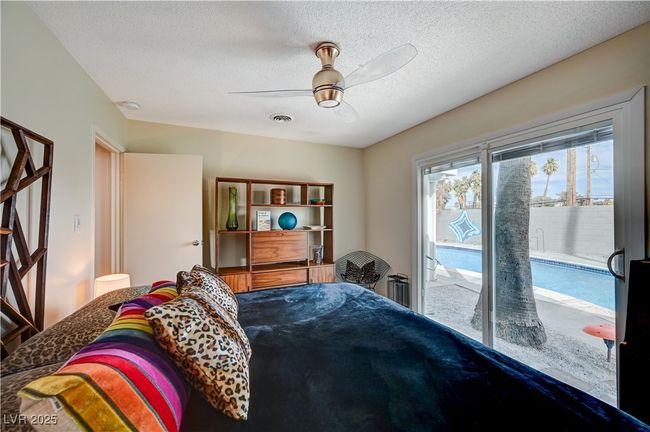Bedroom featuring access to exterior, a textured ceiling, visible vents, and a ceiling fan | Image 28