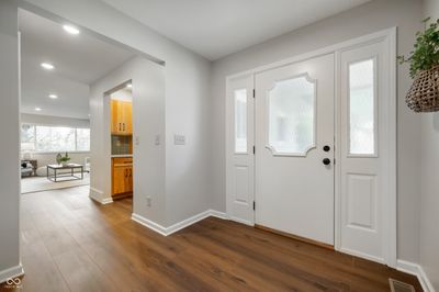 Enter into an open foyer with new flooring and paint. | Image 3