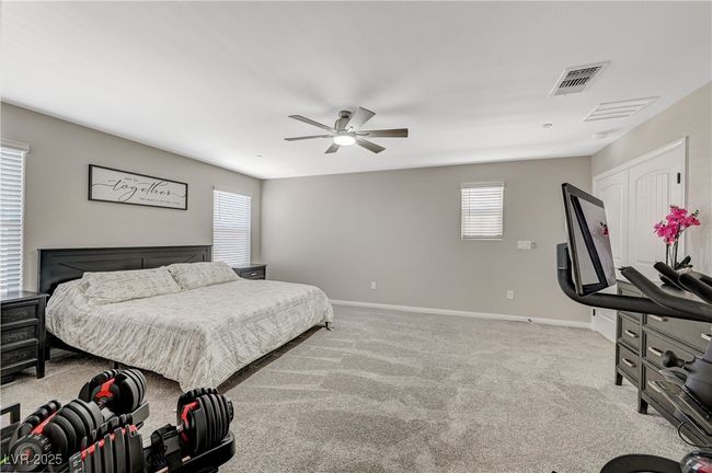 Bedroom featuring baseboards, light carpet, and a ceiling fan | Image 39