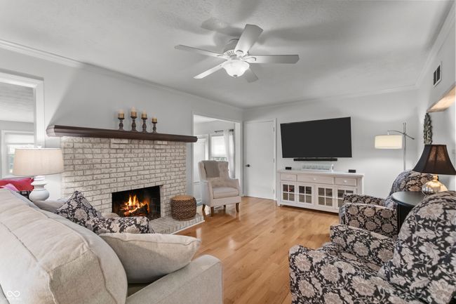 family room open to the kitchen with gas log fireplace. | Image 7