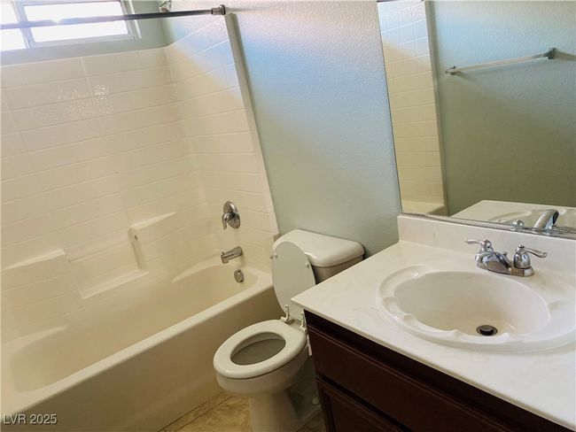 Full bathroom with tile patterned flooring, toilet, vanity, and bathtub / shower combination | Image 21