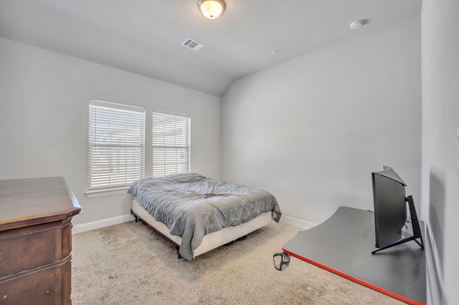 Carpeted bedroom featuring lofted ceiling | Image 21
