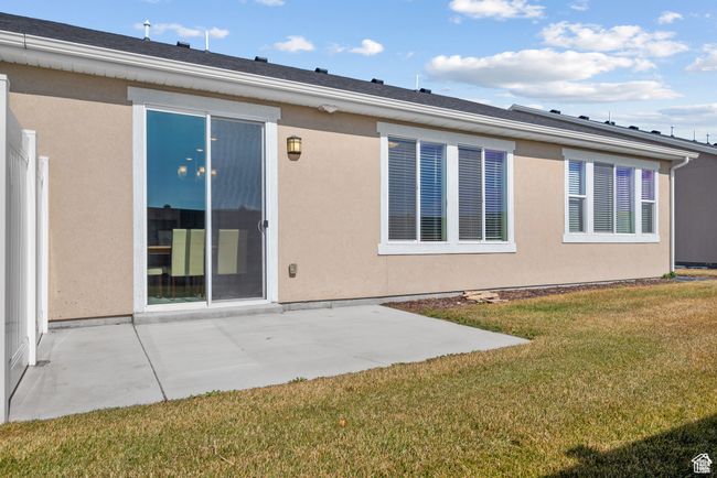 Rear view of property with a lawn, a patio area, and stucco siding | Image 25