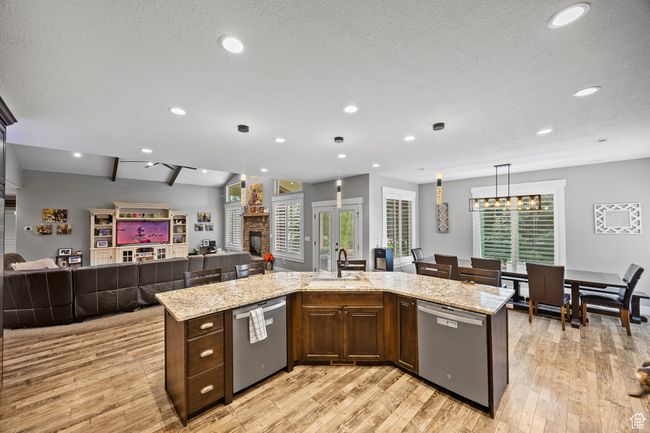 Kitchen with dishwasher, a sink, open floor plan, light wood-style floors, and recessed lighting | Image 25