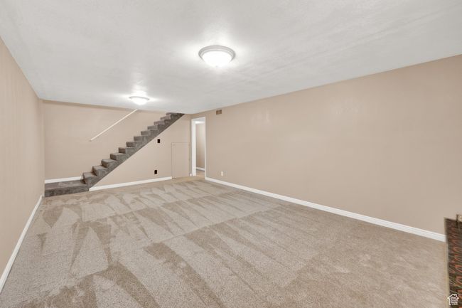 Finished basement featuring carpet, stairway, and baseboards | Image 15