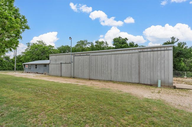 View of green lawn with a pole building, an outbuilding, and driveway | Image 30