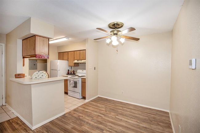 A convenient bar extends from the kitchen, providing additional serving area when entertaining and a perfect spot for casual meals. | Image 15