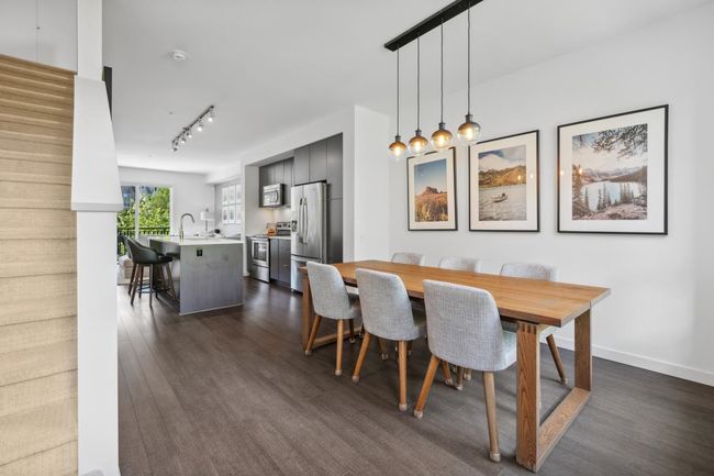 Dining space featuring dark wood finished floors and rail lighting | Image 19