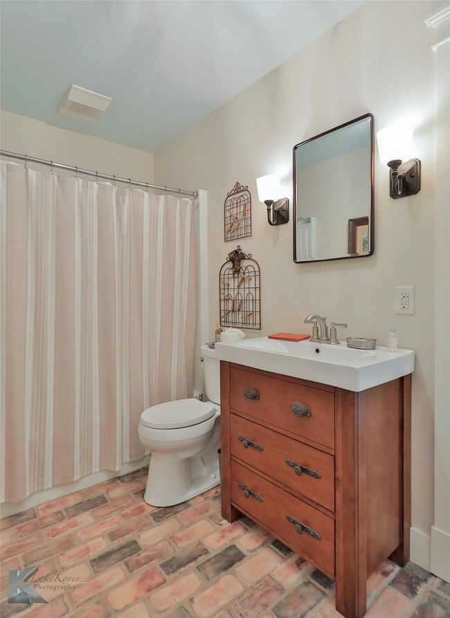 Bathroom featuring vanity and brick patterned flooring | Image 18