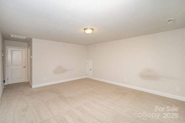This upstairs area could be used as a Bonus, or Media Room with a door, and includes a Full Private Bathroom. This Upper Level Area would be great for guest, or for multi-family living. The separate 4th bedroom is behind the door on the other side of the hallway. The Full bathroom is on the other side of the wall unit. There is walk-in storage behind the little door. This room is Not Staged. | Image 29