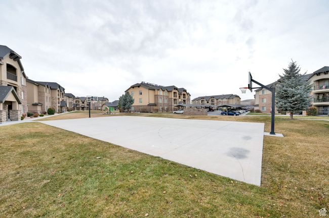 View of sport court featuring a residential view, a lawn, and community basketball court | Image 20