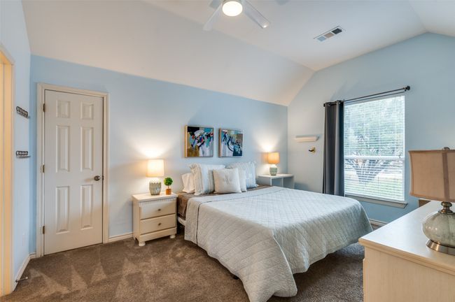 Bedroom with vaulted ceiling, dark carpet, a ceiling fan, and baseboards | Image 16