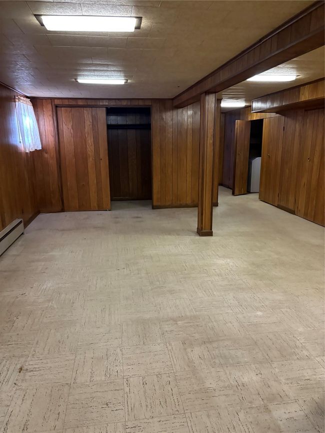 Finished below grade area with wooden walls and light floors | Image 16