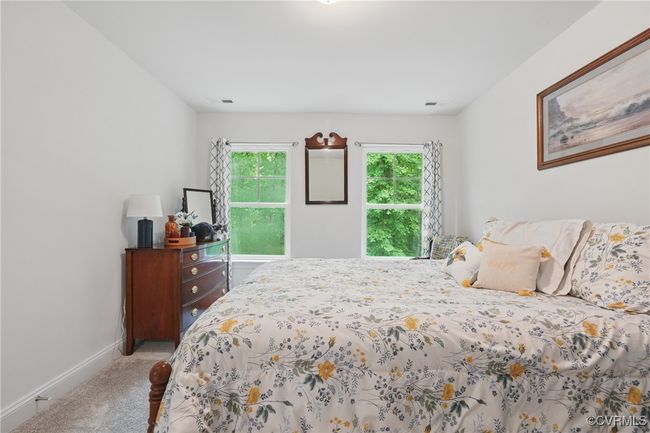 Bright upstairs bedroom with plush carpet and backyard views. | Image 24