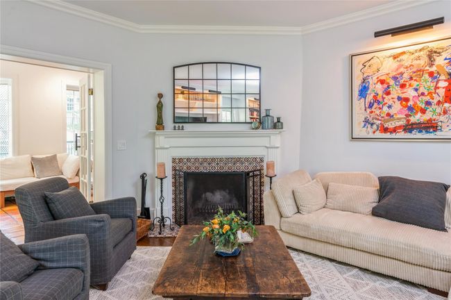 Living room leads seamlessly into den area through French doors. | Image 7