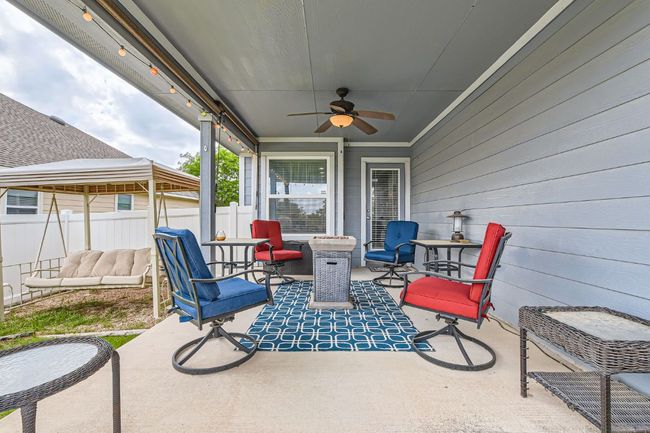 View of patio featuring fence, an outdoor living space, and ceiling fan | Image 23