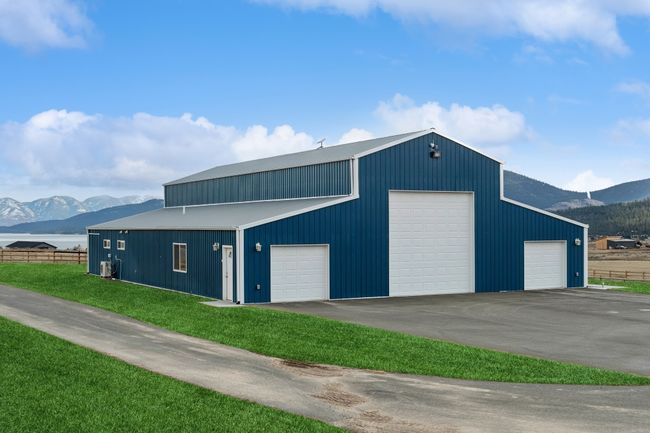 Garage with central air condition unit, a yard, and a mountain view | Image 17