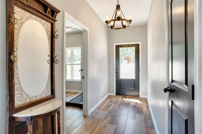 Entrance foyer featuring a healthy amount of sunlight, a notable chandelier, and hardwood / wood-style floors | Image 17