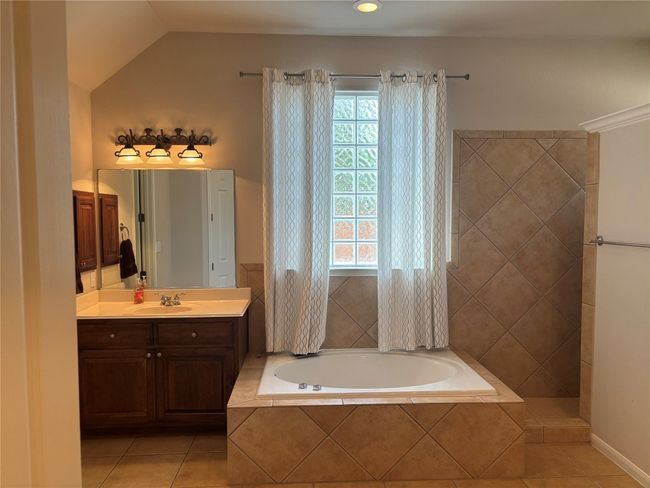 Full bathroom with a bath, tile patterned flooring, and vanity | Image 14