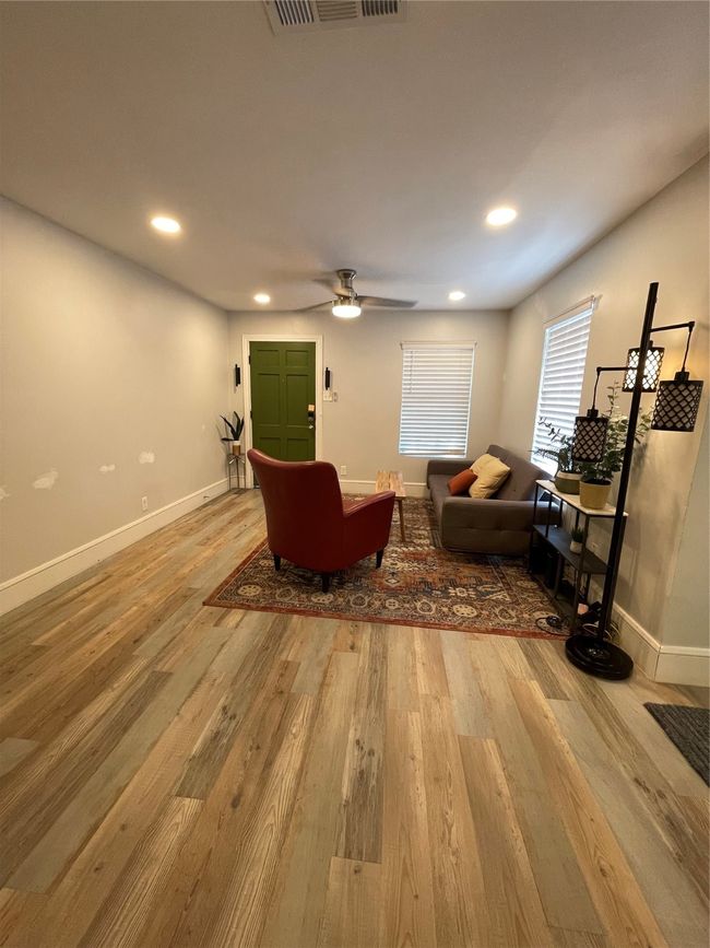 Living area with recessed lighting and light wood-style floors | Image 7
