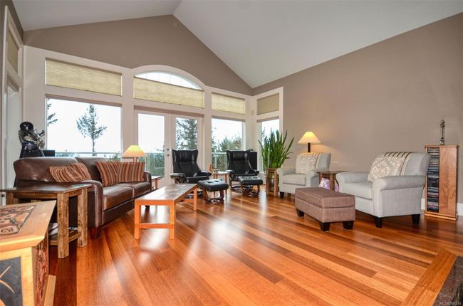 Living room featuring high vaulted ceiling, french doors to deck and hardwood floors | Image 4