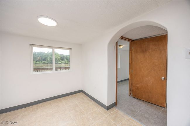 Empty dining area featuring arched walkways and baseboards | Image 22