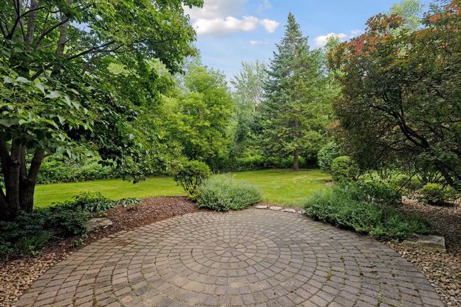 Enjoy seamless indoor-outdoor living with walkout access to a picturesque backyard and patio. | Image 34