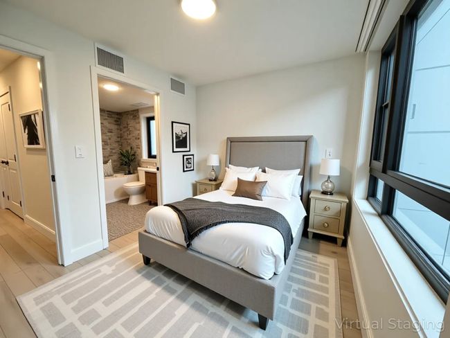 Bedroom featuring baseboards, ensuite bathroom, visible vents, and light wood-style flooring | Image 5