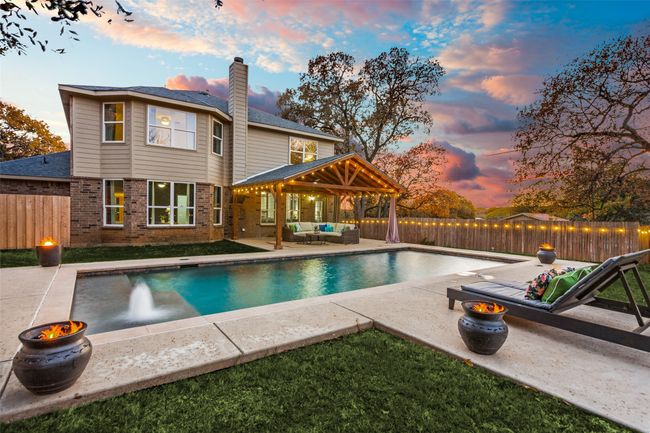 View of pool with outdoor lounge area, a patio, a fenced backyard, and a gazebo | Image 24