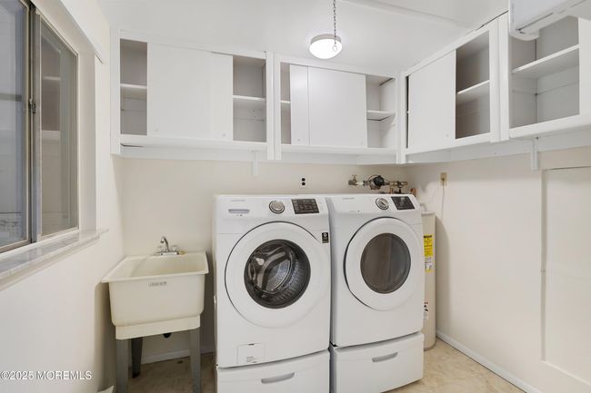 Laundry Tub, Storage cabinets, Pull down access to attic, window out to garage | Image 23