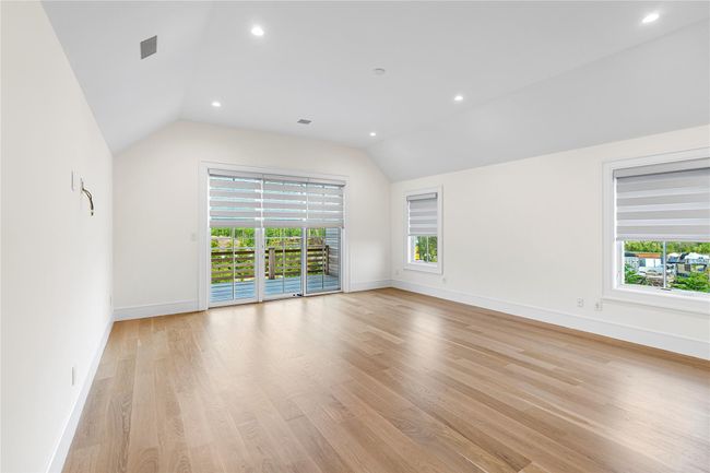Unfurnished room with vaulted ceiling, baseboards, light wood finished floors, and recessed lighting | Image 34