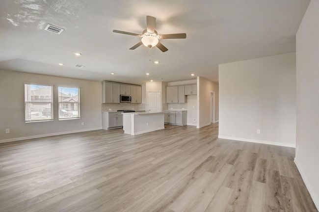 Unfurnished living room featuring ceiling fan, recessed lighting, and light wood-style flooring | Image 6
