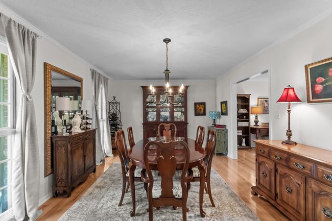 This is the living room that is currently being utilized as a dining room. | Image 15