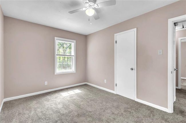 Carpeted empty room with baseboards and ceiling fan | Image 36