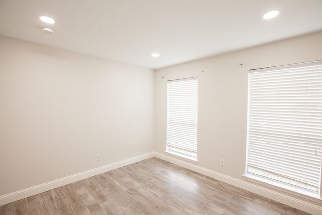 Unfurnished room with a smoke detector, light wood-style flooring, and recessed lighting | Image 26