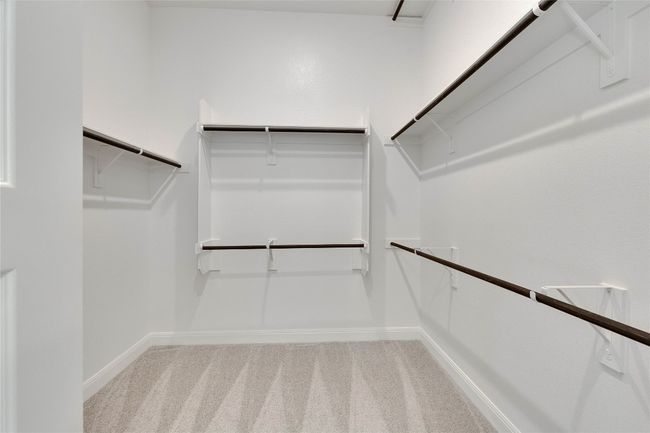 Spacious closet with carpet flooring | Image 10