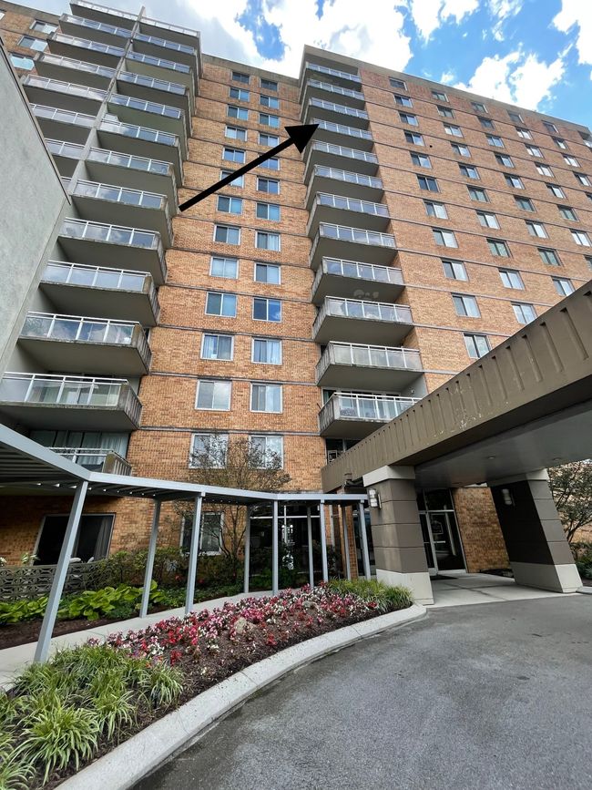 The covered pathway guides you from the garage to the main lobby, ensuring you stay dry even on rainy days. Gaze upward, and you'll notice the desirable location of the balcony for Unit 11k. | Image 21