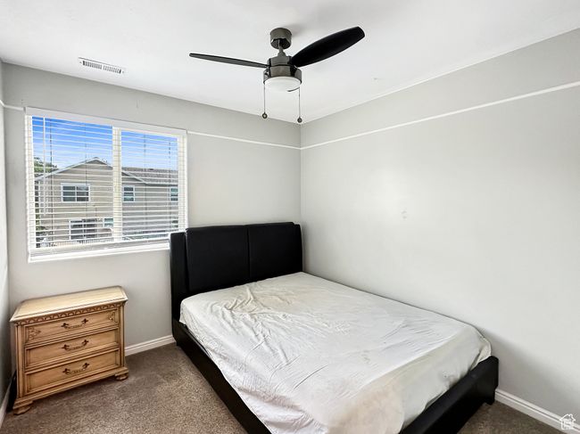 Carpeted bedroom with ceiling fan | Image 14