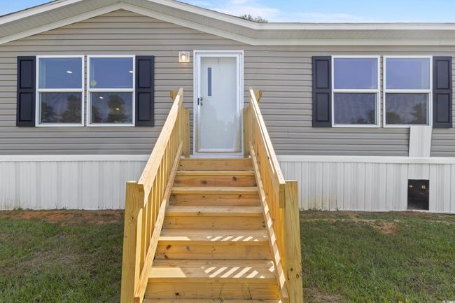 View of exterior entry with a lawn | Image 5
